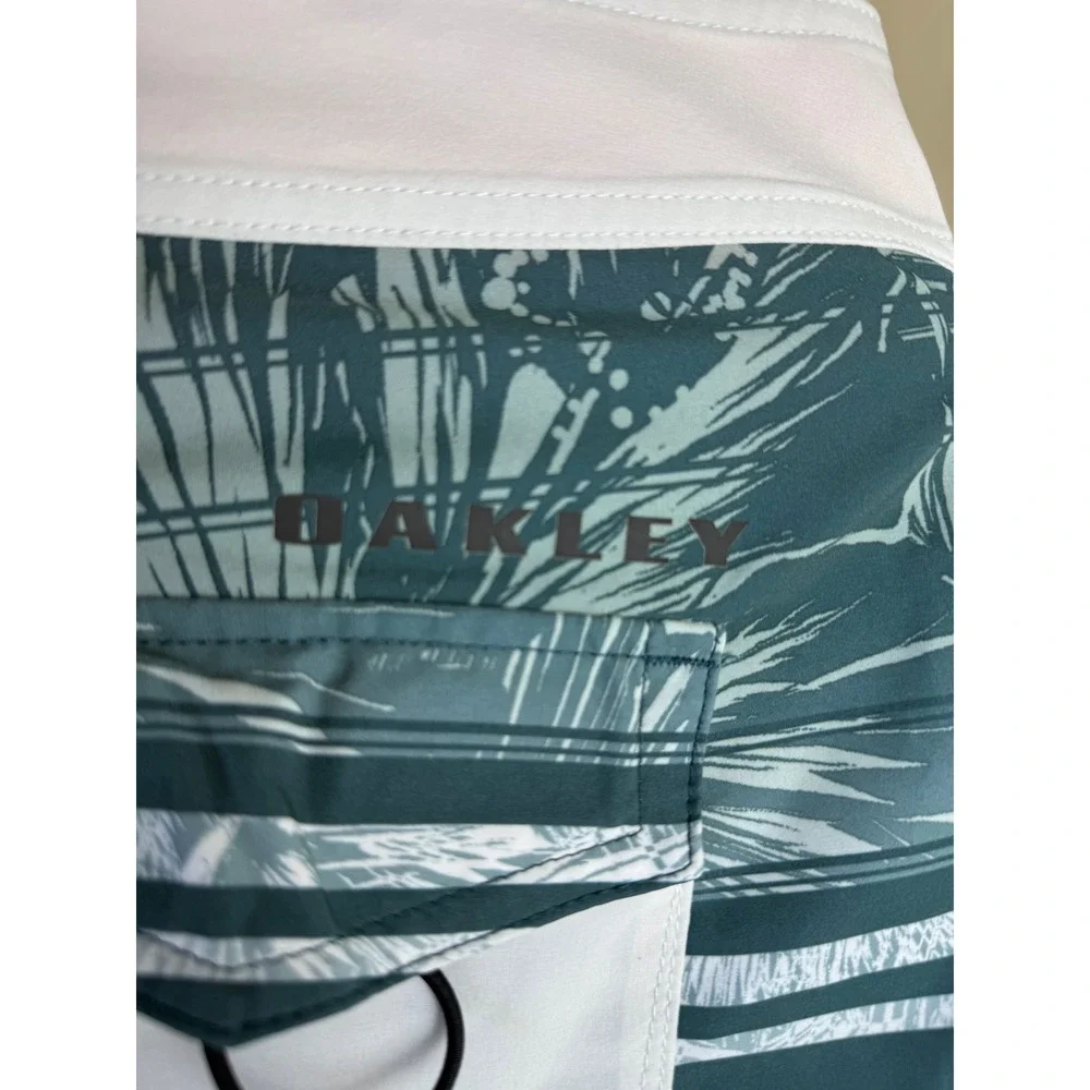 Oakley Mens Board Shorts Teal Green Tropical Palm Stripe Swim Trunks sz 36 Beach